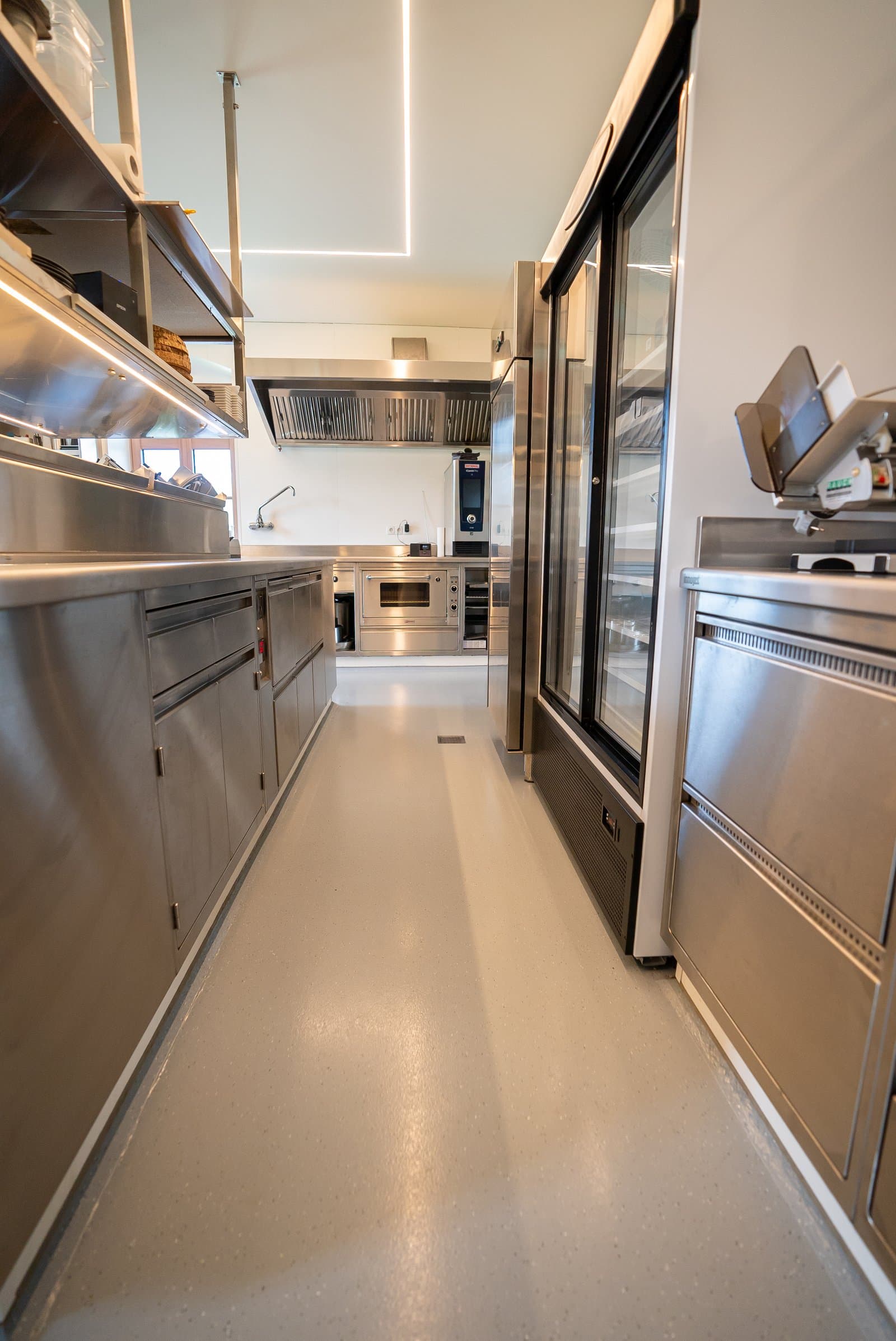 Professionelle Gastroküche mit Edelstahlgeräten und fugenloser Bodenbeschichtung Professionelle Gastroküche mit Edelstahlgeräten und fugenloser Bodenbeschichtung